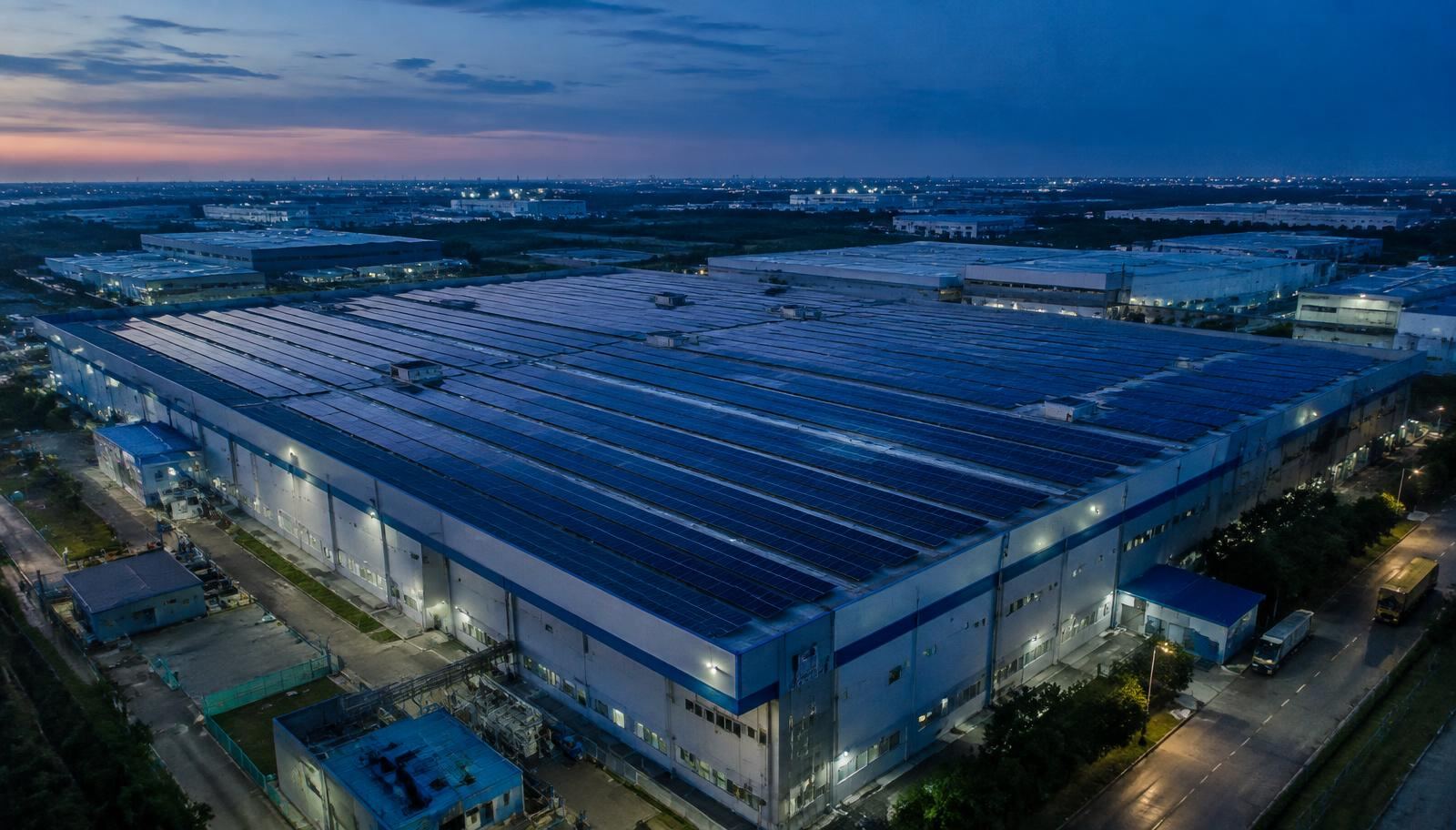 Factory roof covered with solar panels at dusk